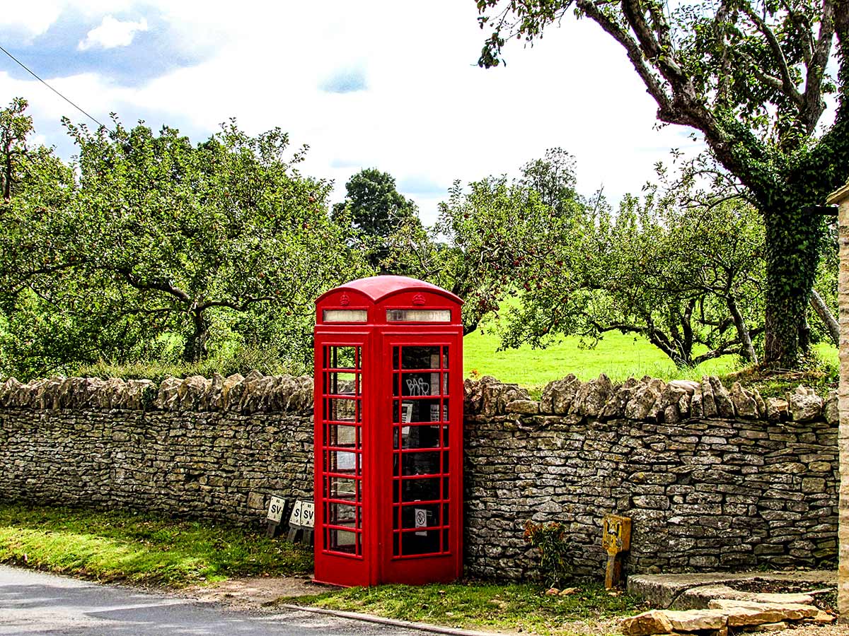 Red phone booth seen near Bibury on Stratford to Bath Cycling Tour