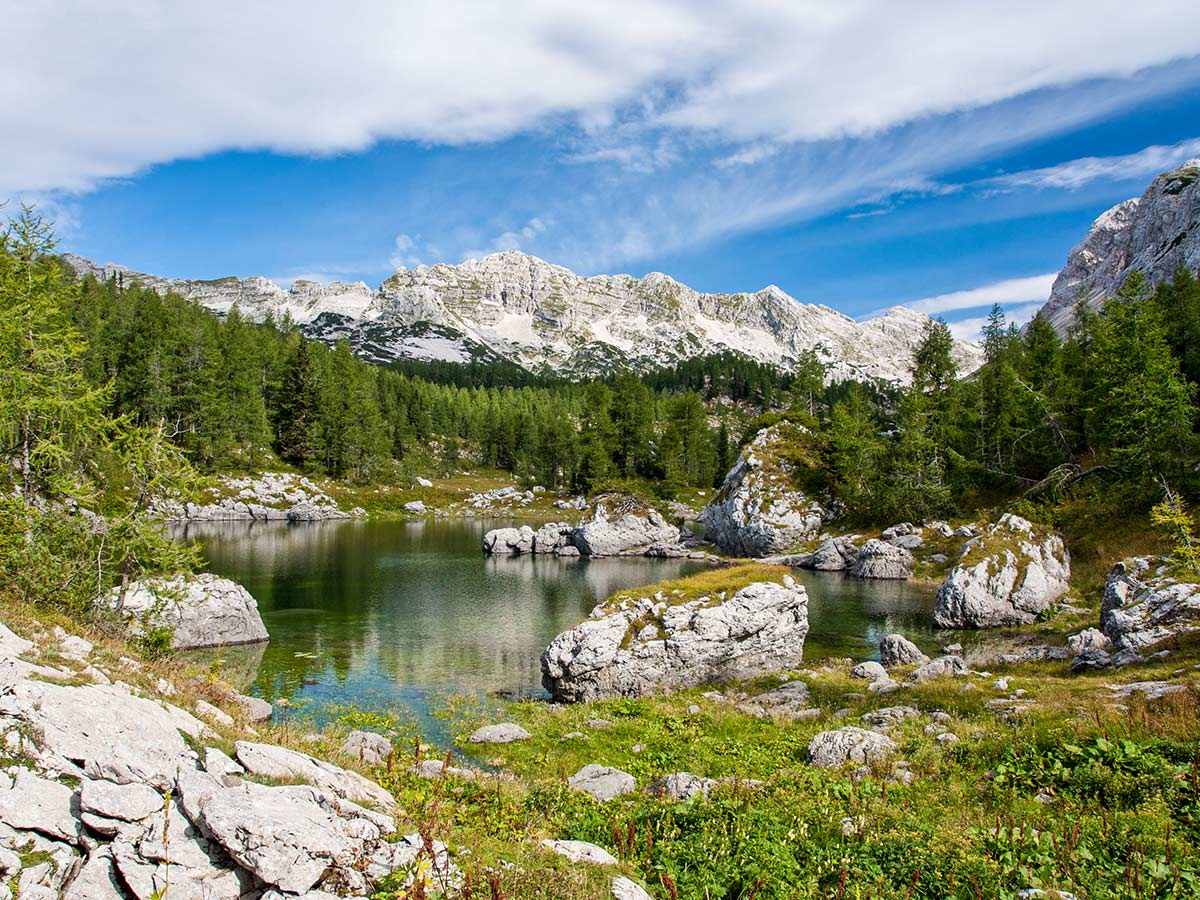 Beautiful tarn in Triglav National Park along the trail of Hiking in Slovenian Alps on Hut to Hut trek