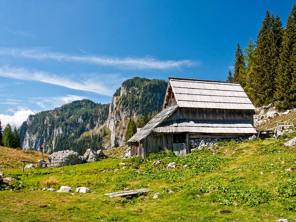 Authentic Slovenian Farmhouses seen on Hiking in Slovenian Alps on Hut to Hut trek with guide