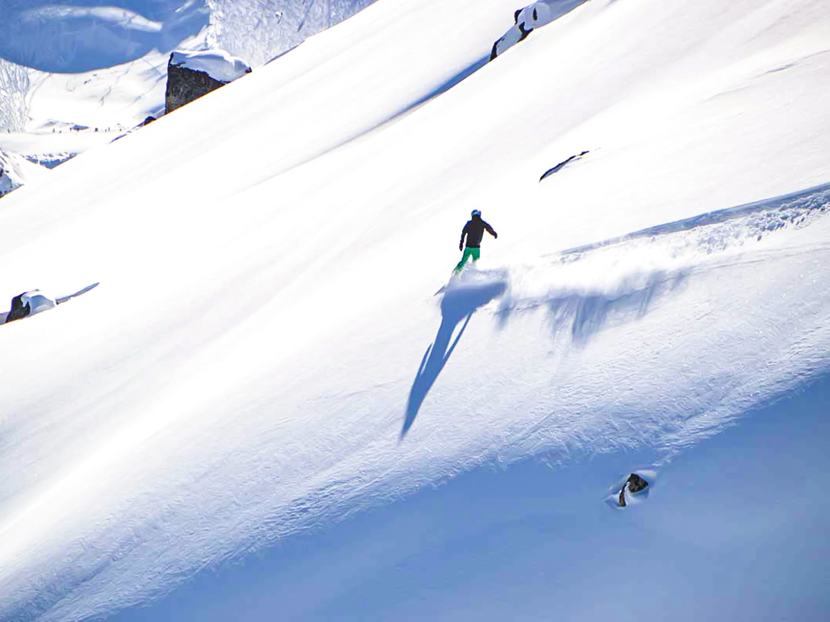 Skier going down the mountain on a guided 9 day ski trip in the Canadian Rockies