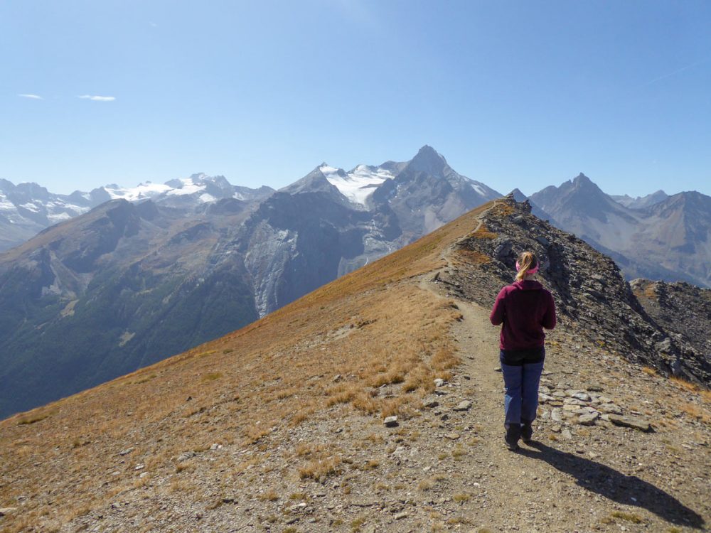 Self Guided Aosta Valley Hiking Tour Italy   S Cape Italy Aosta 05 Hiker Approaching The Col De Tza Seche Peak In Cogne Valley Aosta Italy 1000x750 