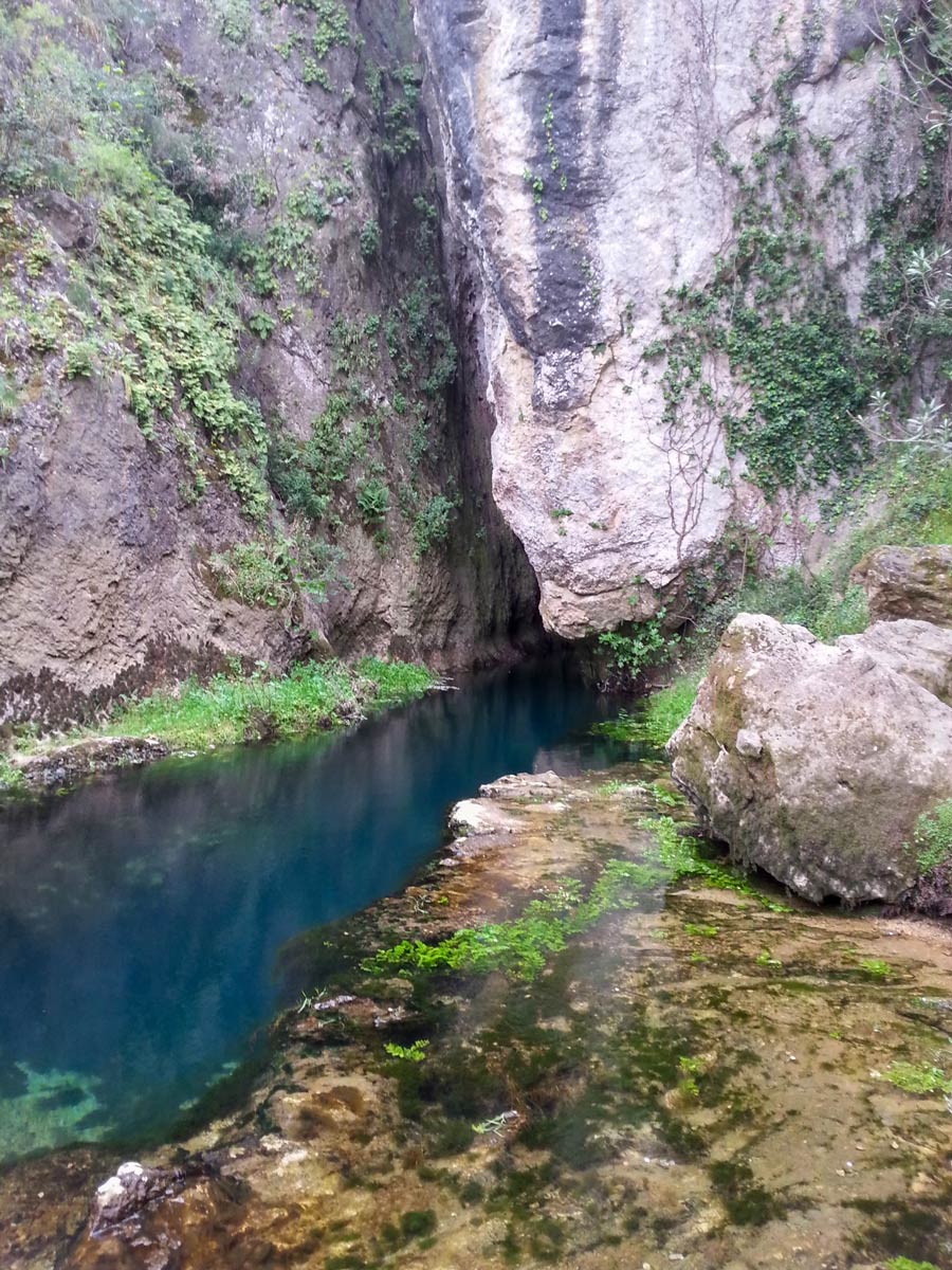 Blue water in the deep canyon seen on self guided walk in Sardinia Italy