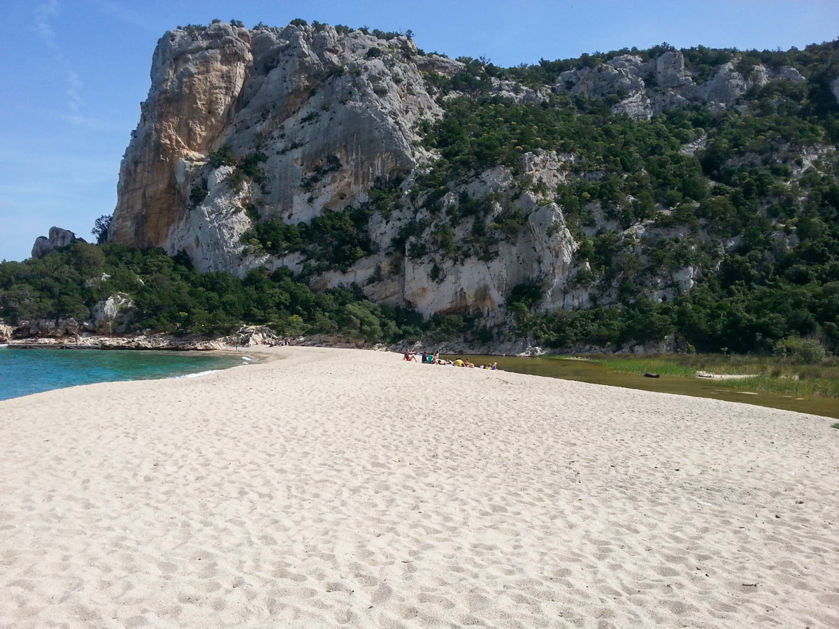 Sandy beach in Sardinia along the walking path of self guided tour