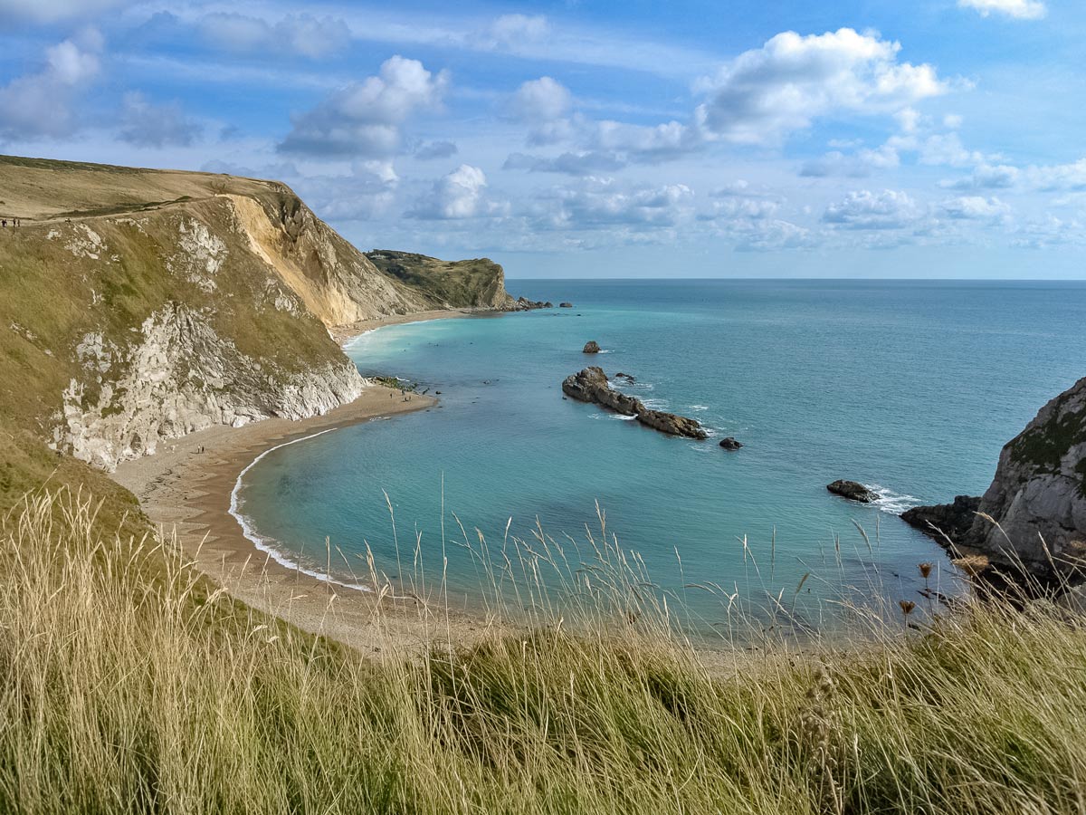 Jurassic Coast exploring bay beach rock cliffs Atlantic ocean England UK