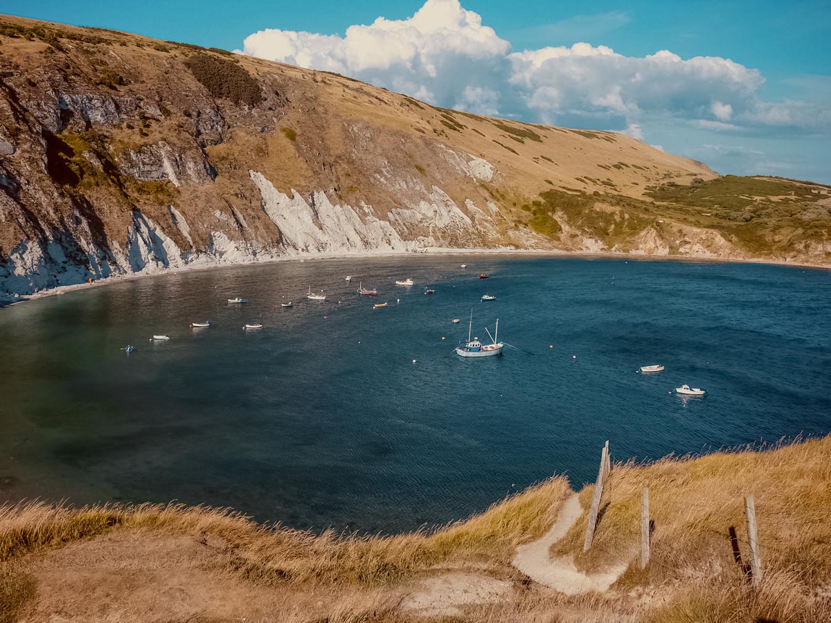 Jurassic Coast Lulworth Cove boats anchored coastal walking England UK