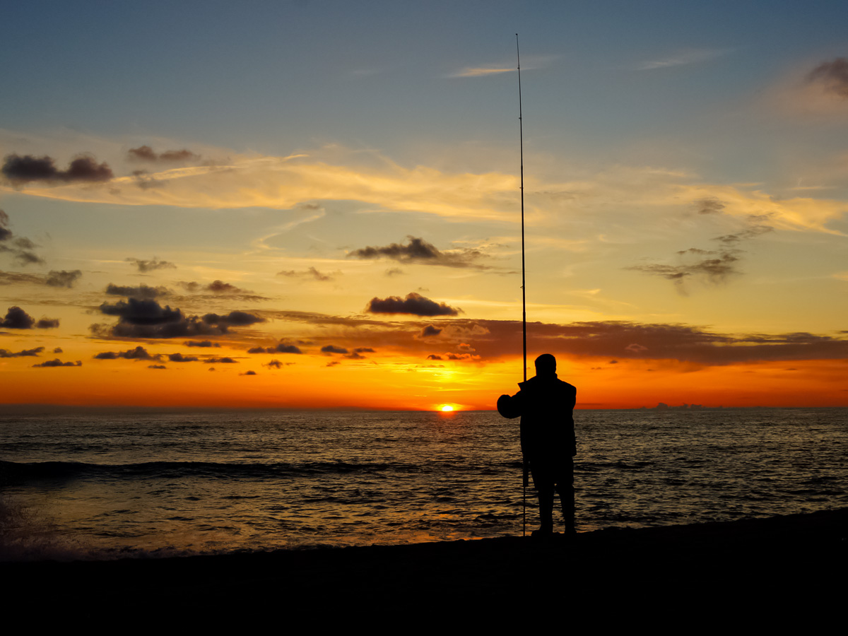 Fisherman on the dock at sunset Munic pio de Esposende