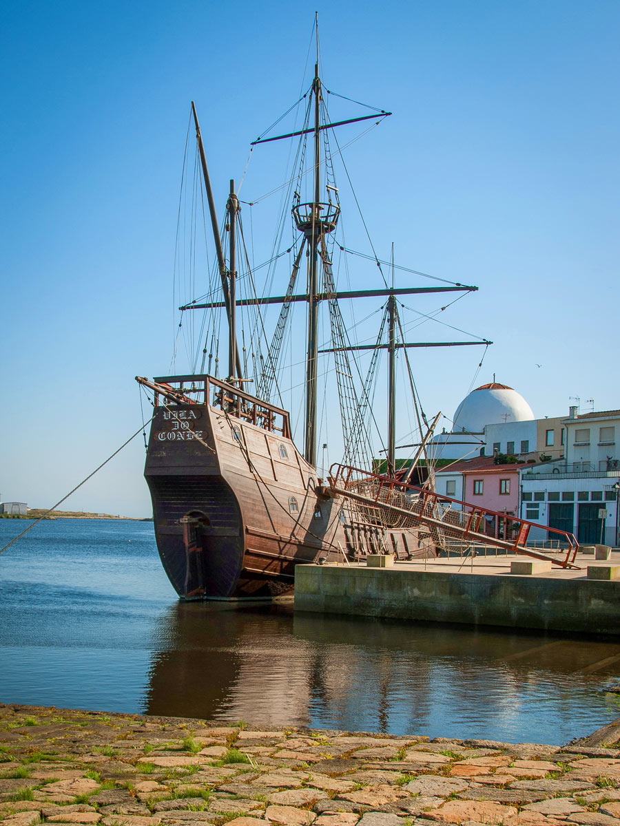 Old style ship moored on dock along bike tour