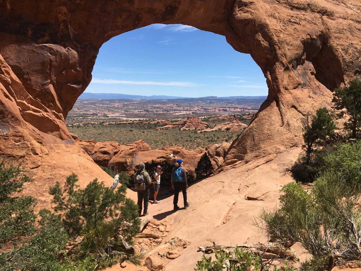 Group of hikers with a guide enjoying the views in Arches National Park