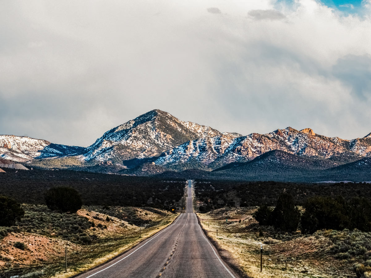 Cedar city straight highway to the mountains driving Bryce Canyon Zion National Park USA