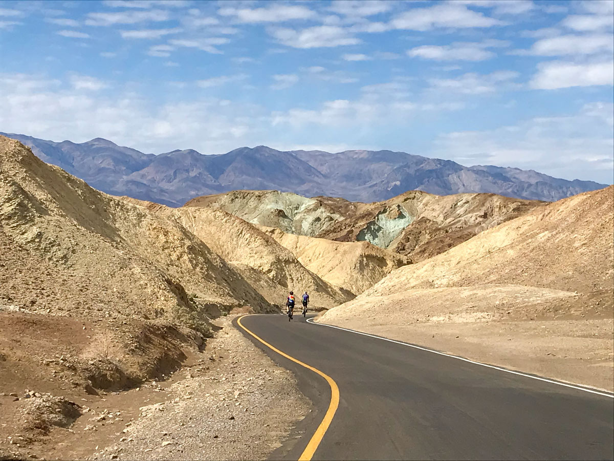 Road biking rock hills blue sky Death Valley National Park Utah