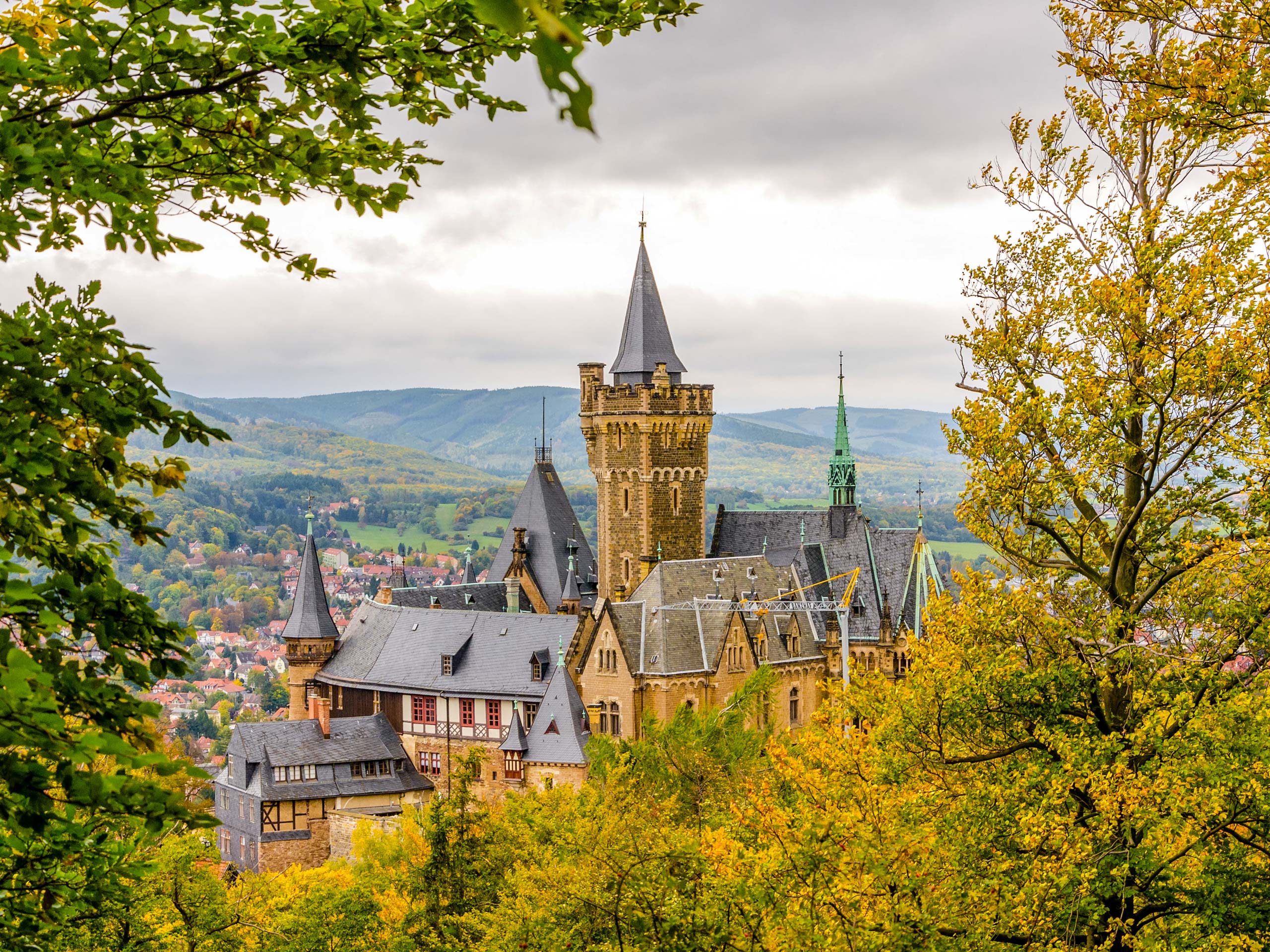 Wernigerode Castle through the trees hiking travelling Harz Witches' Trail