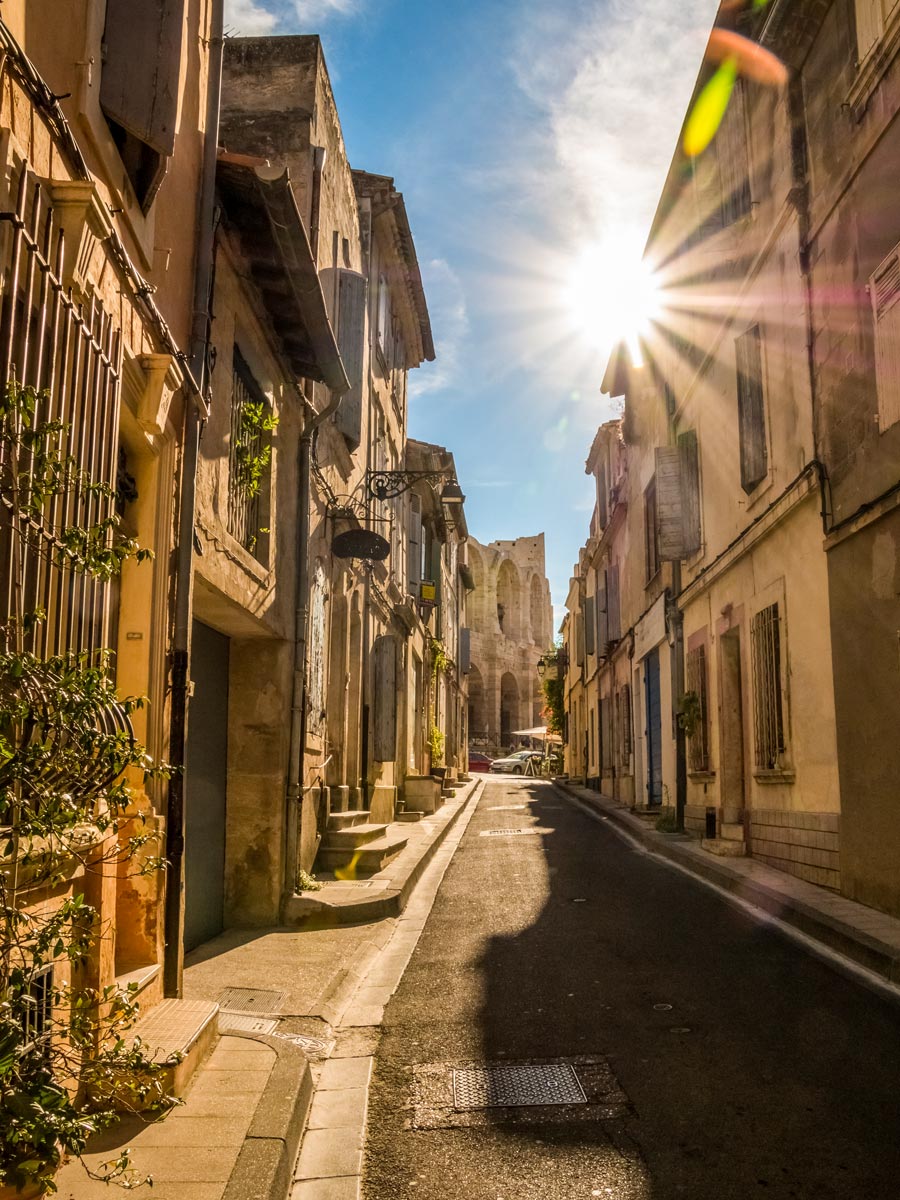 Arles city historic center old stone buildings lining cobblestone streets exploring Provence Alpilles France