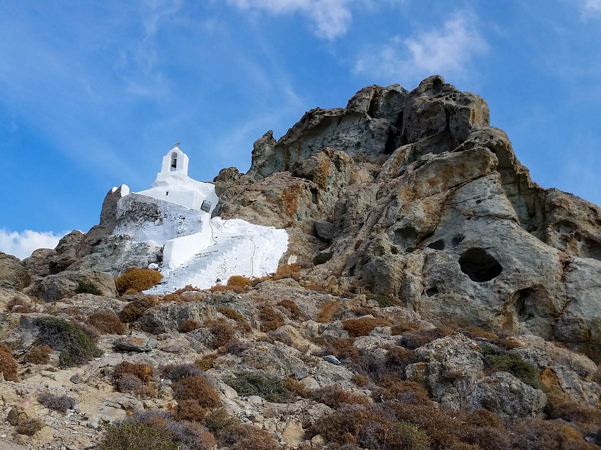 Old white greek church on the hill exploring Naxos and Santorini Greece