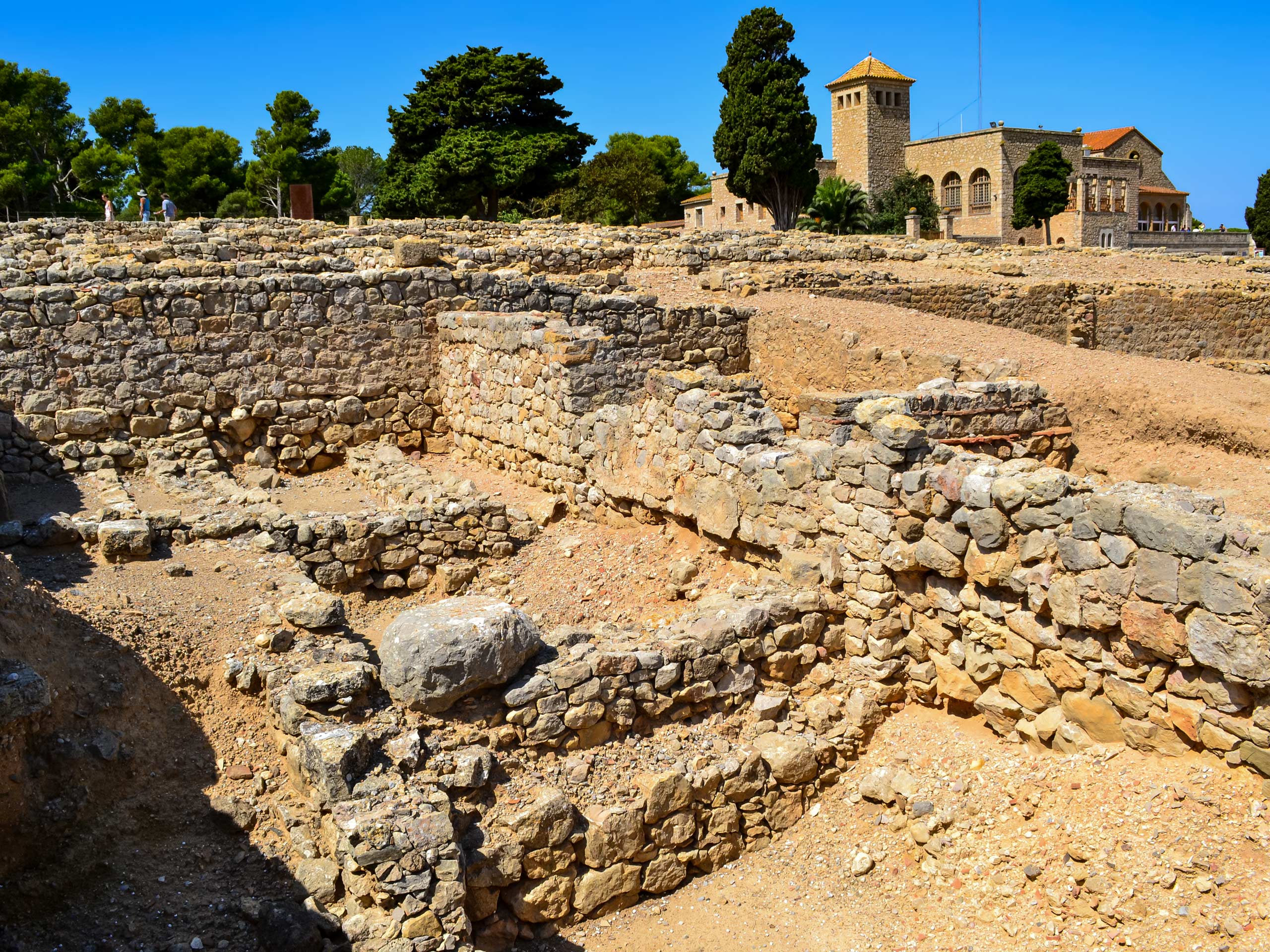 Ancient ruins of Empuries stone foundations in the ground