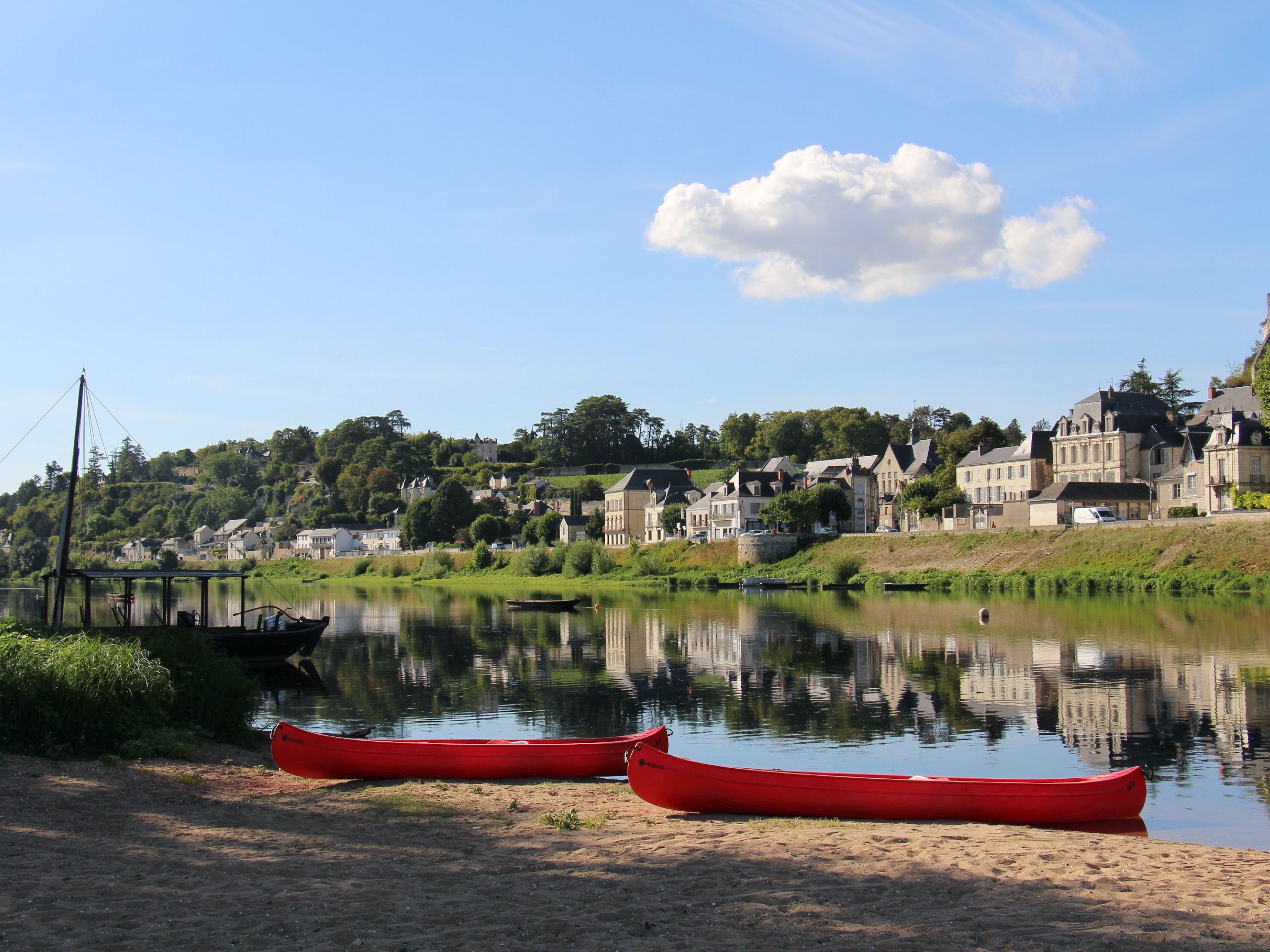 Two red boats near the river in France