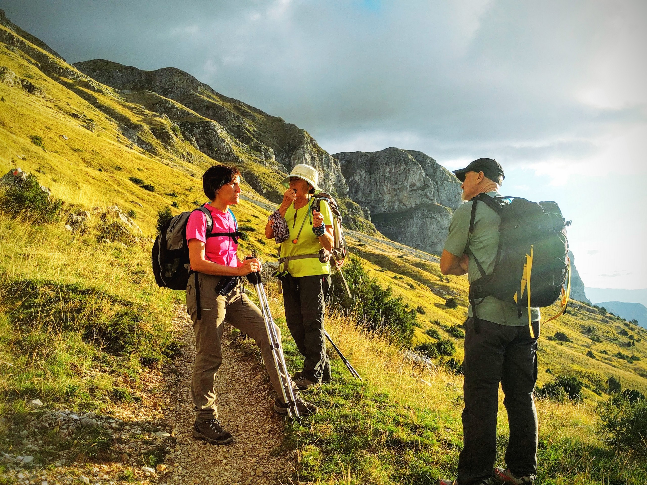 Three hikers resting on one of the trails in Zagori Mountains