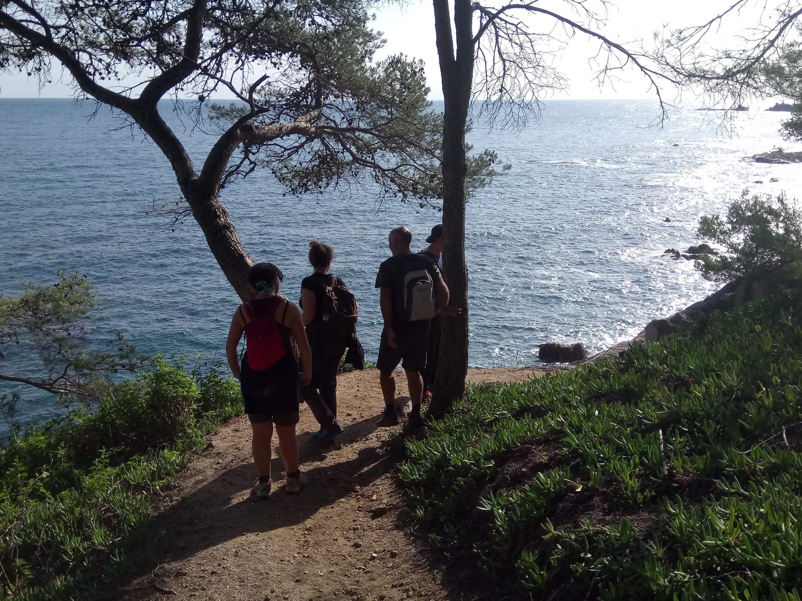 Group of hikers walking along the coast of Costa Brava