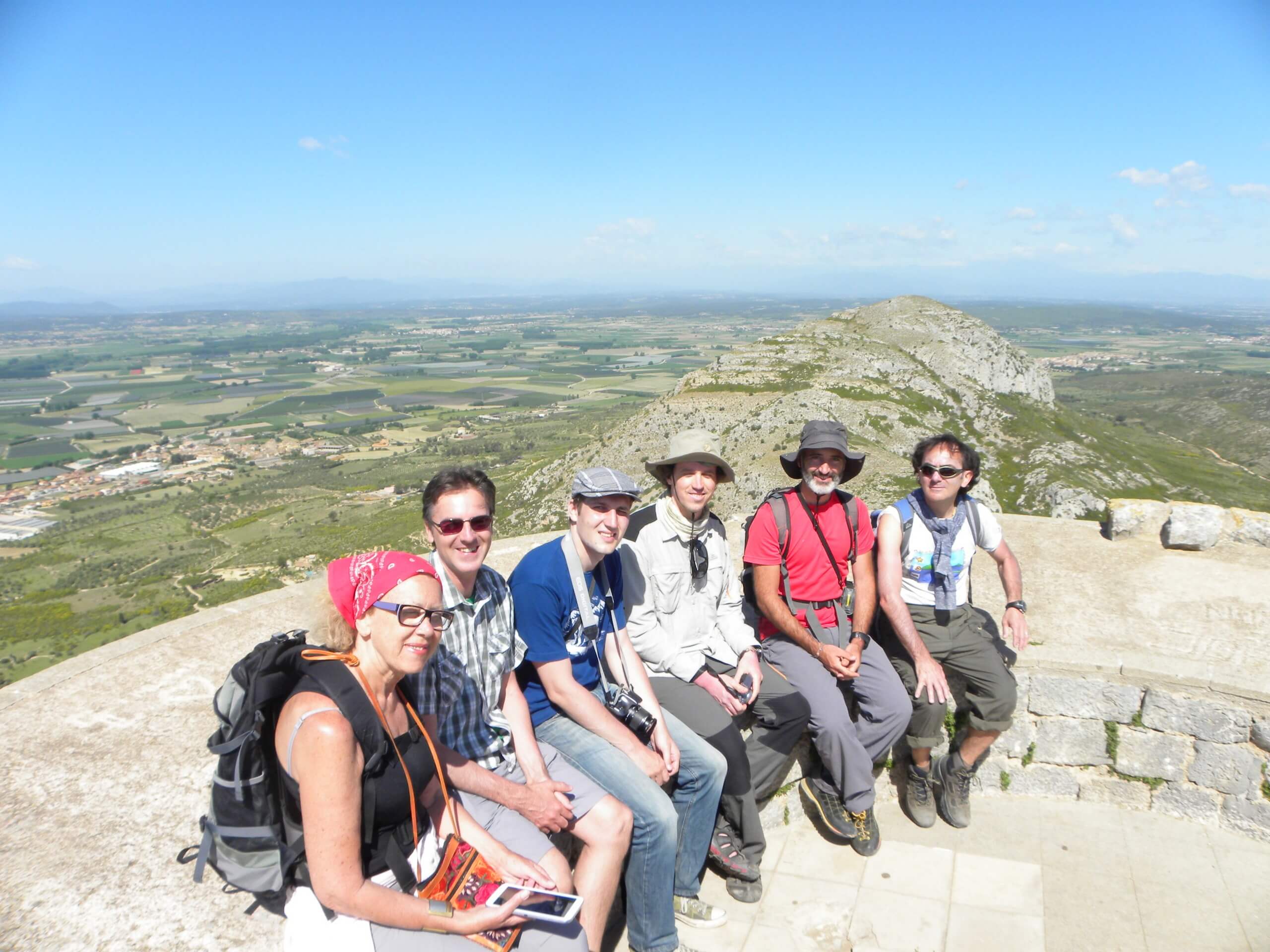 Group of hikers resting on top of the hill in Costa Brava