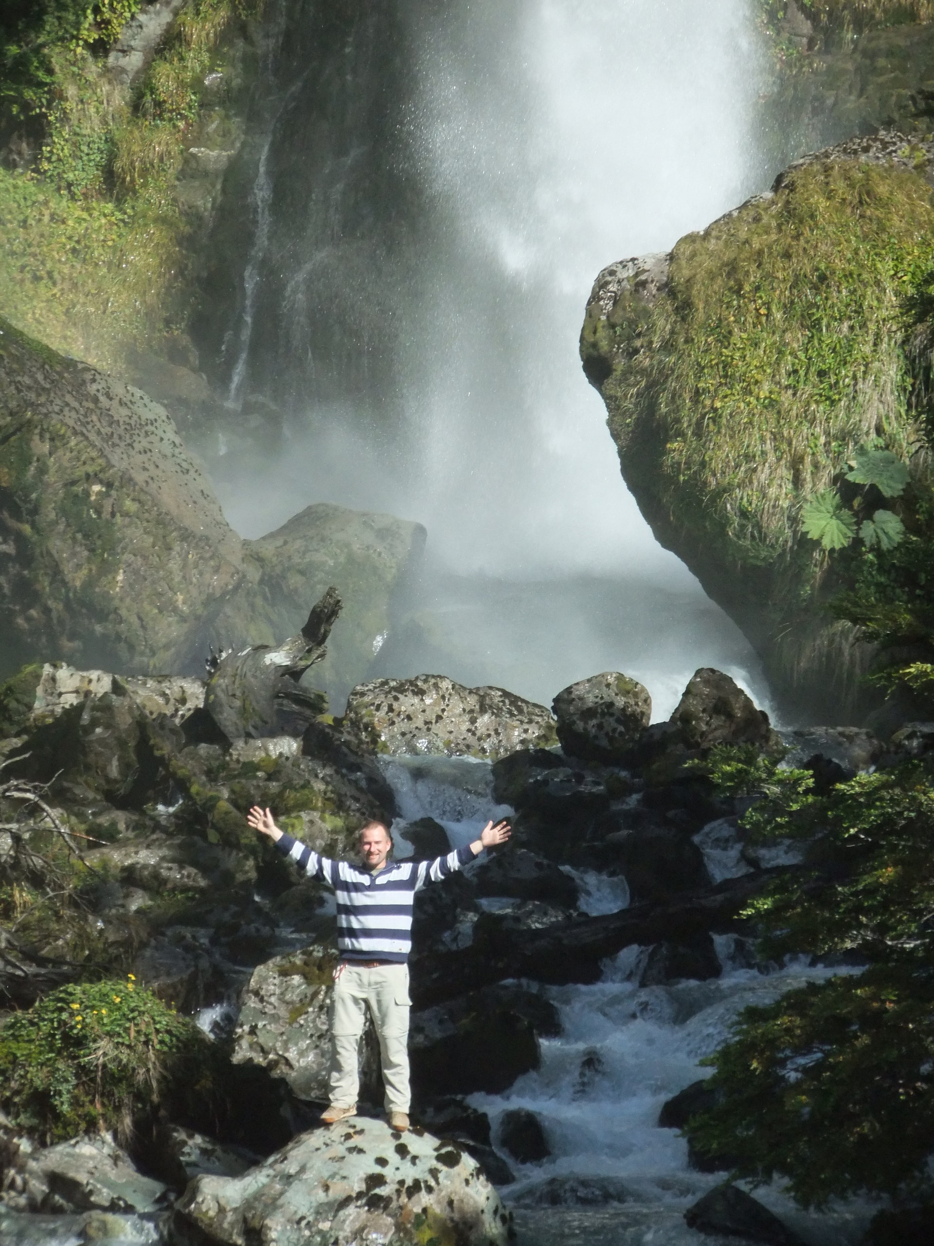 Hiker posing near waterfal