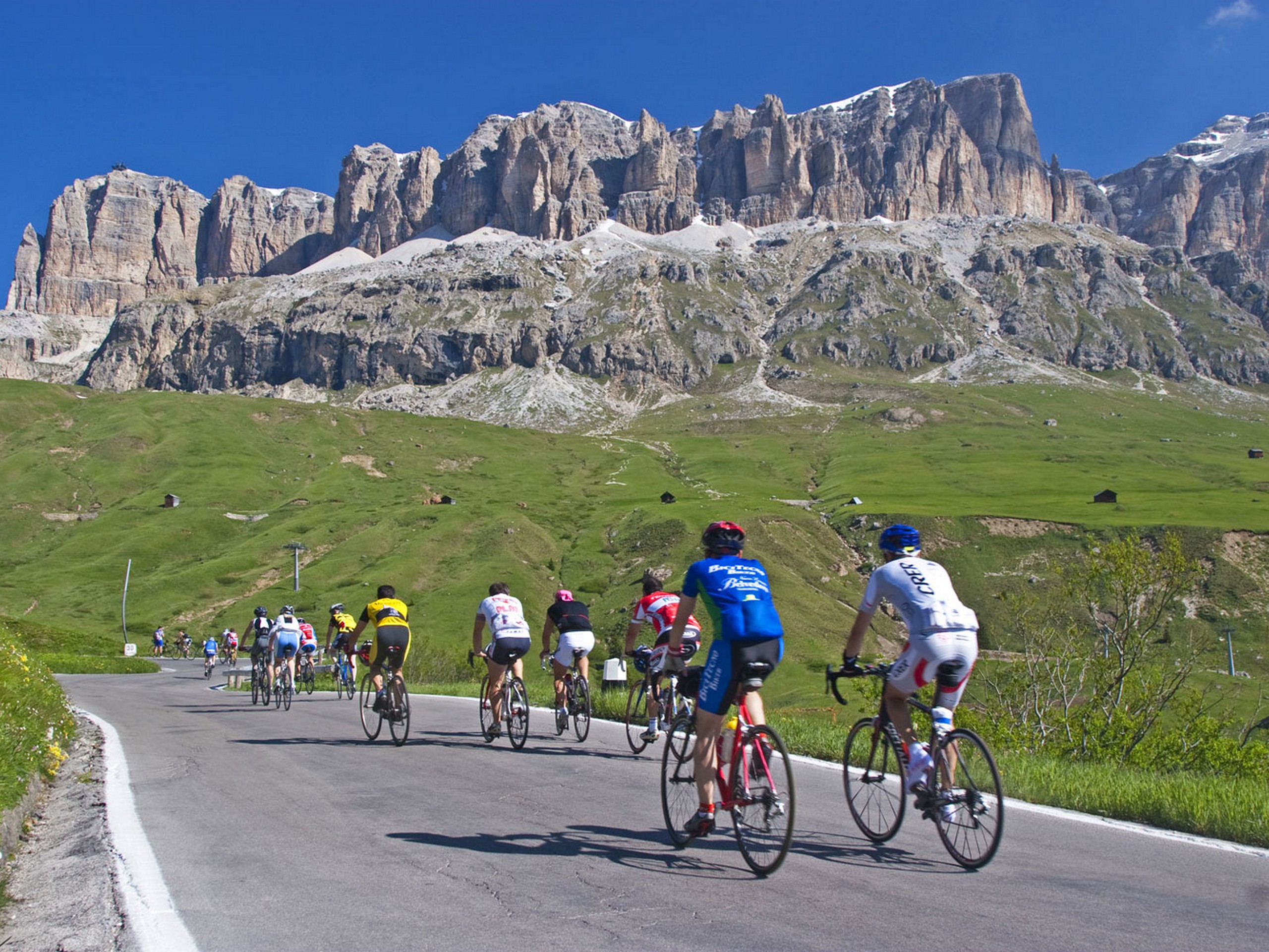 Group of cyclists biking in Dolomite Alps in Italy