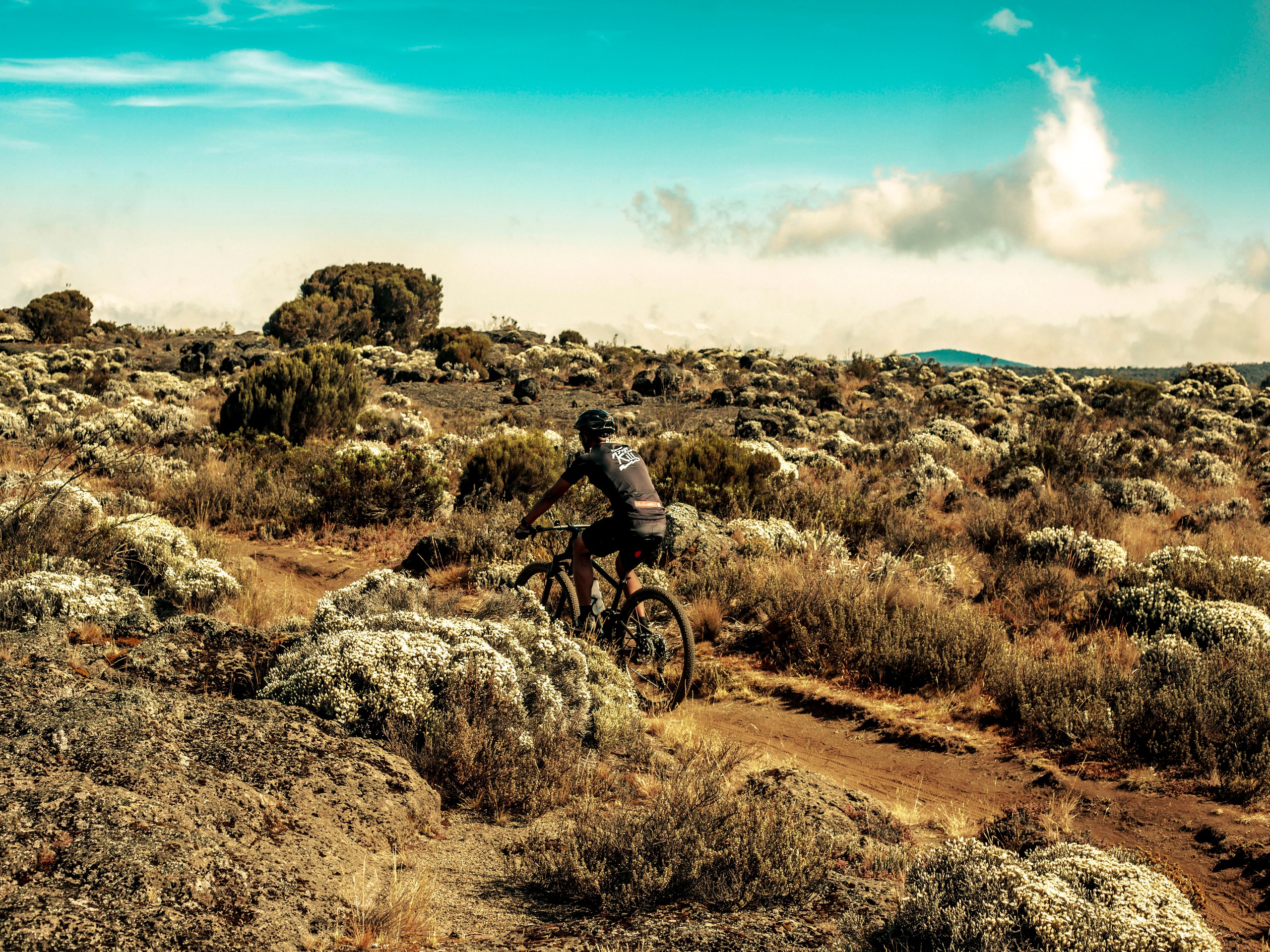 Biker riding up the Mount Kilimanjaro trail in Tanzania