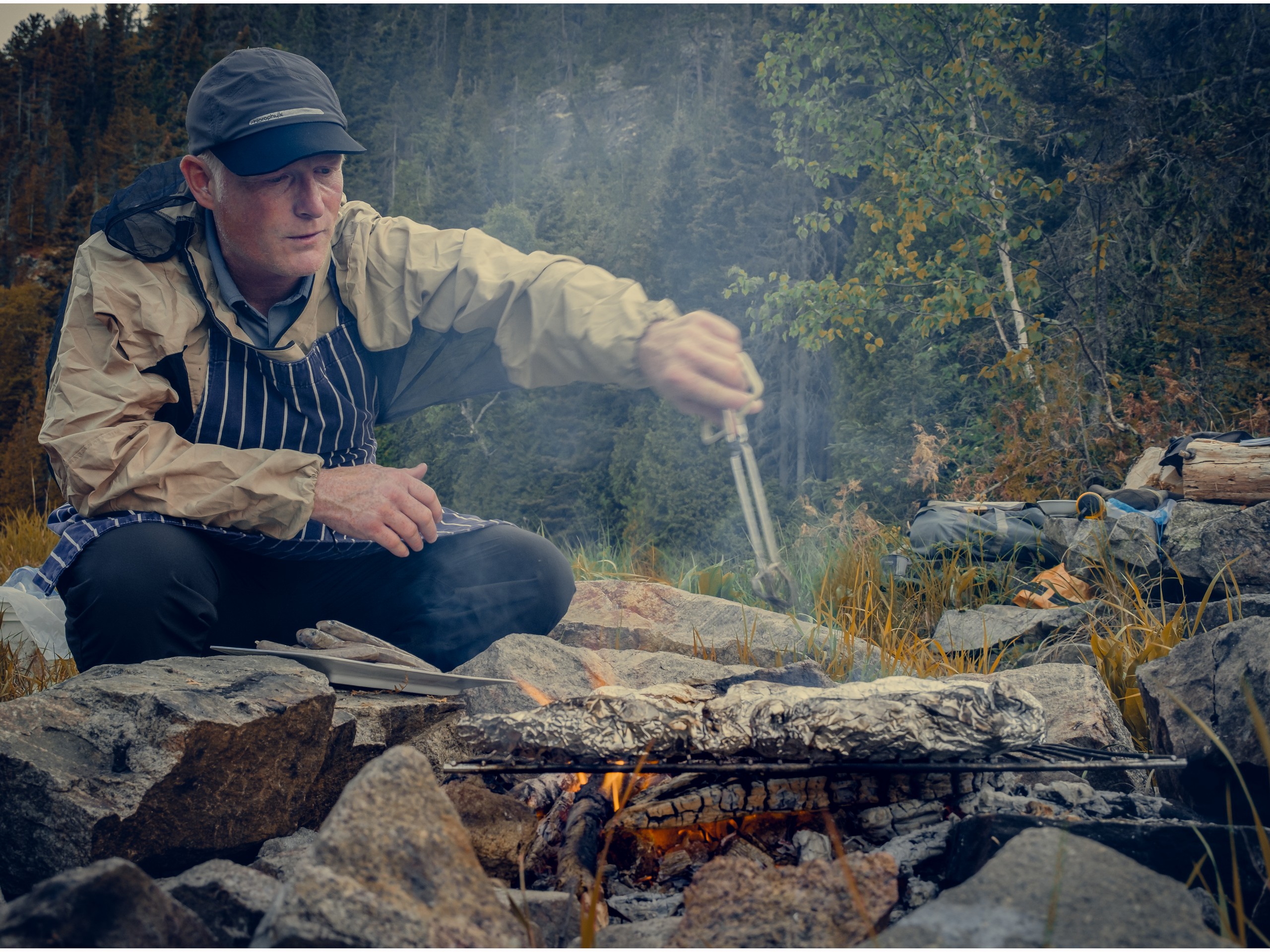 Resting near the fire pit while on kayaking trip in Quebec